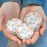 Midsummer Floral Bridesmaid Button<br><div class="desc">Identify the key players at your bridal shower with our elegant,  sweetly chic floral buttons. Button features a watercolor floral wreath of peachy pink peonies,  white hydrangea flowers and botanical greenery with "bridesmaid" inscribed inside in hand lettered script.</div>