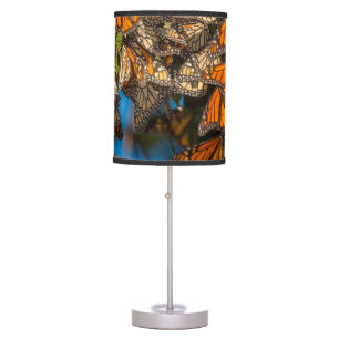 Migrating monarch butterflies cling to leaves table lamp