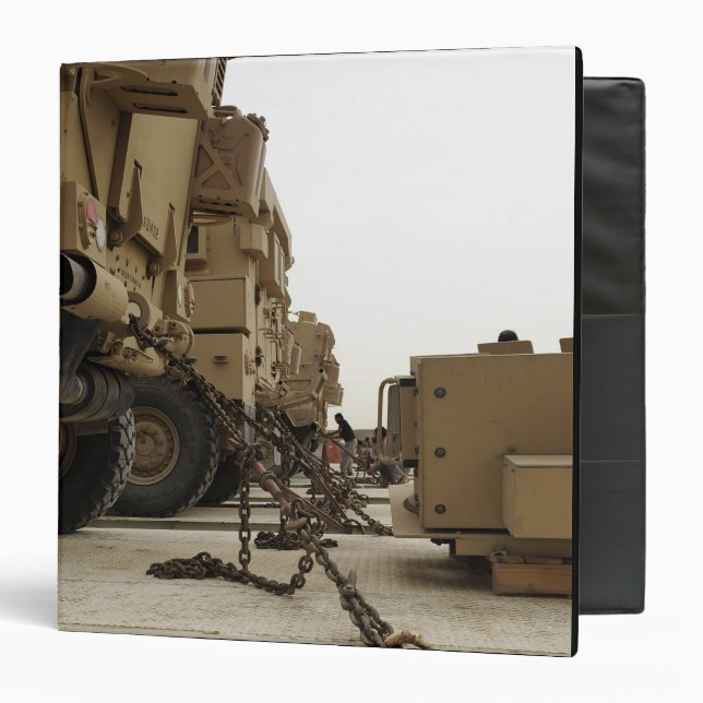 Military vehicles are locked down on semi truck binder (Front/Inside)