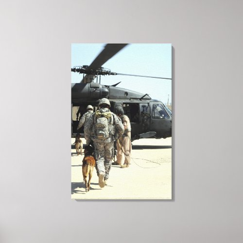 Military working dog handlers board a helicopte canvas print