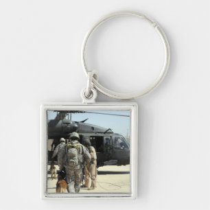 Military working dog handlers board a helicopte keychain