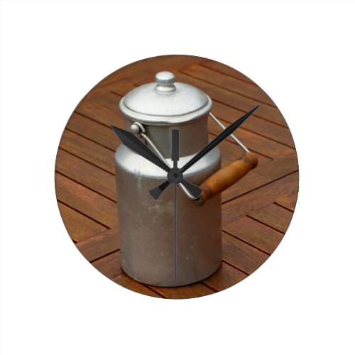 Milk can on a table round clock