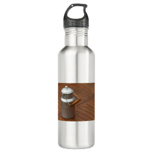 Milk can on a table stainless steel water bottle
