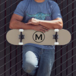 Minimal Black Monogram Skateboard<br><div class="desc">A minimalist monogram design with black monogram emblem with classic block typography initial on a simple beige background.</div>