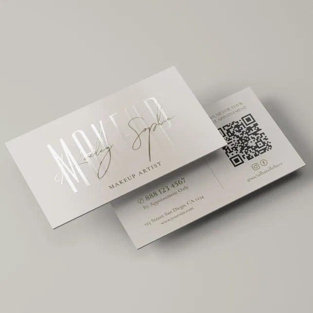 A silver makeup artist's business card featuring UV gloss and a QR code.