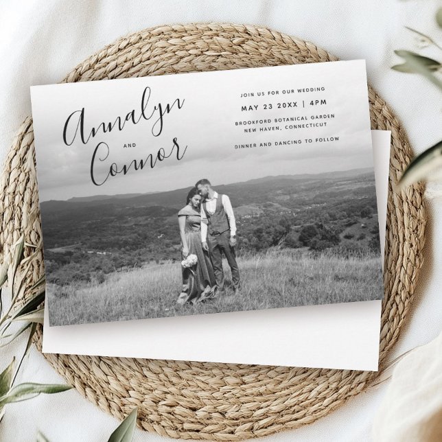 Minimal Script Photo | Modern Monochrome Wedding Invitation (Black and white wedding invitation featuring a couple embracing in a vast landscape. Elegant script )