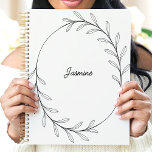 Minimalist Black Leaf Wreath Custom Name Planner<br><div class="desc">This elegant design features a minimalist black line-drawn wreath of delicate leaves encircling a customizable name in a stylish script. The clean and modern aesthetic makes it perfect for professionals, students, or anyone who appreciates simple and sophisticated designs. Ideal for organizing tasks, journaling, or planning with a touch of understated...</div>