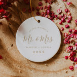 Minimalist Gold First Christmas Wedding Photo Ceramic Ornament<br><div class="desc">This minimalist gold first Christmas wedding photo ceramic ornament is the perfect simple Christmas tree decoration. The design features classic gold and white typography paired with a rustic yet elegant script font with hand lettered style. This keepsake ornament reads "our first Christmas as mr and mrs". Personalize the front with...</div>