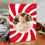Minimalist Red and White Peppermint Swirl Photo Holiday Card<br><div class="desc">Modern holiday card featuring your photo encircled by a white frame with a red and white peppermint swirl background. The phrase "Merry and Bright" is displayed in curved white lettering. Personalize the peppermint swirl Christmas card with your family name. The back of the card features a red background with subtle...</div>