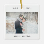 Minimalist Typewriter | Merry and Married Photo Ceramic Ornament<br><div class="desc">These simple and minimalist Christmas holiday ornaments feature your favorite wedding photo on the front along with your initials, the year, and the words "merry and married" in black typewriter look text. The back features another of your wedding photos, lightened with an overlay so that you can add additional text...</div>