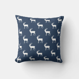 Minimalist white reindeer pattern on blue throw pillow