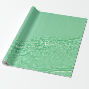 Mint blue colored clear water surface texture with wrapping paper