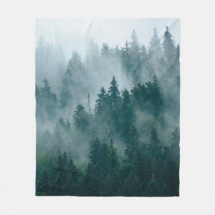 Misty landscape with fir forest in hipster vintage fleece blanket