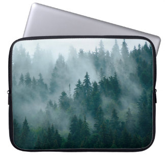 Misty landscape with fir forest in hipster vintage laptop sleeve