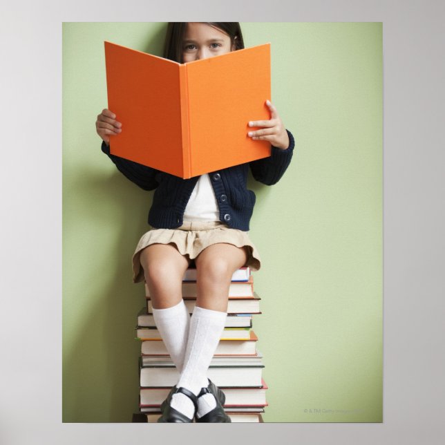 Mixed race girl sitting on stack of books poster (Front)