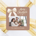 Mocha coffee cream bow photo script Christmas Square Sticker<br><div class="desc">A muted mocha coffee background,  cream colored text and a bow. Merry Christmas is written with an elegant hand-lettered style font. Personalize and add your family name.</div>