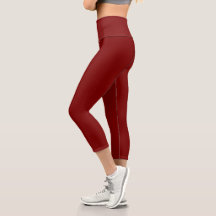 model wearing fitted, deep red leggings