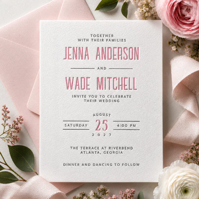 A pink, modern letterpress invitation. Flowers can be seen in the background.