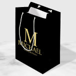 Modern Black and Gold Personalized Groomsman Medium Gift Bag<br><div class="desc">Modern Black and Gold Personalized Groomsman Gifts featuring personalized monogram, groomsman's name and title in gold classic serif font style on black background. Also perfect for Best Man, Father of the Bride and more. Please Note: The foil details are simulated in the artwork. No actual foil will be used in...</div>