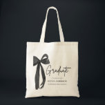 Modern Black Bow Coquette Graduate Graduation Tote Bag<br><div class="desc">Celebrate in style with our Modern Black Bow Coquette Graduate Graduation Tote Bag 🎓🖤 Featuring a chic black bow and sleek minimalist design, this tote is perfect for carrying all your grad day essentials or gifting to your favorite graduate. Stylish, functional, and oh-so-cute ✨👜 A fabulous keepsake they’ll love long...</div>