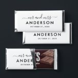 Modern Black Monogram Mr and Mrs Hershey Bar Favors<br><div class="desc">A bold and contemporary wedding favor wrapper featuring "Mr and Mrs" in flowing calligraphy script with the couple's surname displayed as a commanding monogram centerpiece. Deep black tones create a dramatic, high-impact design with effortless sophistication. Personalize with your names and wedding date for a standout reception favor. All text is...</div>