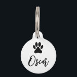 Modern Black Pet Paw Print with Phone Number Pet ID Tag<br><div class="desc">Pet ID tag with stylized black pet, dog paw print and customizable pet name on the front and text template with phone number on the back. The background color is white and can be changed as desired. This easy to personalize pet collar pendant is a nice gift idea for all...</div>