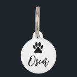Modern Black Pet Paw Print with Phone Number Pet ID Tag<br><div class="desc">Pet ID tag with stylized black pet, dog paw print and customizable pet name on the front and text template with phone number on the back. The background color is white and can be changed as desired. This easy to personalize pet collar pendant is a nice gift idea for all...</div>