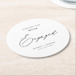 Modern Black & White Calligraphy Engagement Party Round Paper Coaster<br><div class="desc">Introducing our Modern Black & White Calligraphy Engagement Party Round Paper Coaster! Celebrate your engagement party with these elegant and personalized coasters that feature the words "We're Engaged" in beautiful calligraphy. The coaster is designed to be simple yet stylish with a modern touch, making it perfect for any modern wedding...</div>