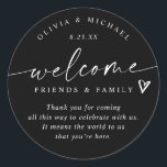 Modern Black & White Wedding Welcome Hotel Bag Classic Round Sticker<br><div class="desc">Black and White Hotel Bag Stickers: Make a sleek first impression with these black and white modern handwriting wedding welcome stickers. Each 3-inch round label features the phrase “welcome friends & family” in crisp white script with a small heart accent and room for your short message. The couple’s names and...</div>