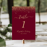 Modern Burgundy Red Gold Glitter Edge Wedding Table Number<br><div class="desc">The top edge of this elegant modern wedding table number features a gold faux glitter design. The customizable text combines pale gold-colored handwriting,  copperplate and italic fonts on a burgundy red background.</div>