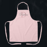Modern Chic Script Blush Pink Monogram Name Apron<br><div class="desc">Modern Chic Script Blush Pink Monogram Name Apron is designed with customizable pastel pink background and dark dusty rose monogram initial on the center.  Personalized with name in classy light grey calligraphy script lettering in white.
CLICK PERSONALIZE TEMPLATE OPTION AND ENTER MONOGRAM AND NAME.</div>