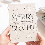 Modern Cream Merry and Bright Non-Photo Holiday Card<br><div class="desc">Modern holiday card featuring "Merry and Bright" displayed in black lettering and cream background with subtle black dots (snow). Personalize the front of the non-photo holiday card with your family name and the year in black lettering. The card reverses to display your personal message in black lettering or leave it...</div>