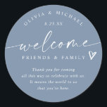 Modern Dusty Blue Wedding Welcome Hotel Bag Classic Round Sticker<br><div class="desc">Dusty Blue Hotel Bag Stickers: Welcome guests to your celebration with these dusty blue modern handwriting hotel bag stickers, a stylish way to complete your welcome gifts. Each 3-inch round sticker features the phrase “welcome friends & family” with a small heart accent above your short message. The couple’s names and...</div>