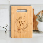 Modern Eucalyptus Elegant Monogram Wedding Gift Cutting Board<br><div class="desc">An elegant charcuterie and cutting board that would make a perfect wedding or newlyweds gift for a couple, featuring a personalized template for the couple's last name monogram framed by a wreath of whimsical hand-drawn eucalyptus leaves, and first names and the wedding year in simple modern calligraphy. Elegant and modern,...</div>