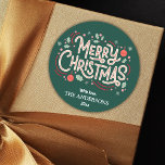 Modern festive cute green & white Merry Christmas Classic Round Sticker<br><div class="desc">Celebrate the holidays in style with this modern sticker featuring a green background and cheerful white and red typography. The "Merry Christmas" message is adorned with holly, snowflakes, and baubles, creating a playful yet elegant design. Customizable with your family name and year, this sticker is perfect for adding a personal...</div>