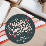 Modern festive dark teal & white Merry Christmas  Classic Round Sticker<br><div class="desc">Celebrate the holidays in style with this modern round sticker featuring a dark teal background and cheerful white and red typography. The "Merry Christmas" message is adorned with holly, snowflakes, and baubles, creating a playful yet elegant design. Customizable with your family name and year, this sticker is perfect for adding...</div>