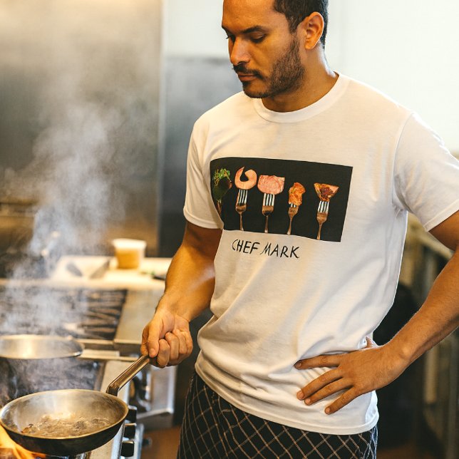 Modern Food Forks Restaurant Chef Shirt (Chef at the sauté station in bold fork-and-food tee, steam rising in a pro kitchen blaze)