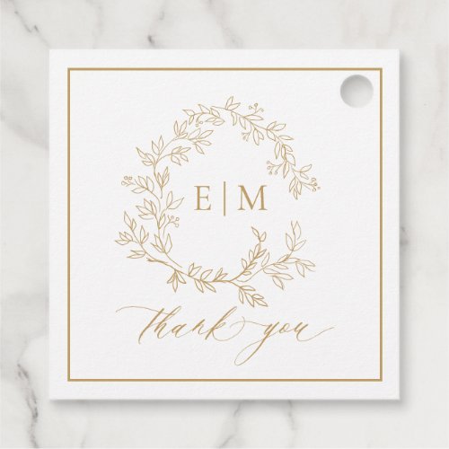 Modern Gold Leafy Crest Monogram Wedding Favor Tags - send your guest home with a thank you gift adorned with this trendy favor tag! We're loving this trendy, modern gold wedding design! Simple, elegant, and oh-so-pretty, it features a hand drawn leafy wreath encircling a modern wedding monogram. It is personalized in elegant typography, and accented with hand-lettered calligraphy. Finally, it is trimmed in a delicate frame. Veiw suite here: https://www.zazzle.com/collections/gold_leafy_crest_monogram_wedding-119668631605460589 Contact designer for matching products to complete the suite, OR for color variations of this design. Thank you sooo much for supporting our small business, we really appreciate it! 
We are so happy you love this design as much as we do, and would love to invite
you to be part of our new private Facebook group Wedding Planning Tips for Busy Brides. 
Join to receive the latest on sales, new releases and more! 
https://www.facebook.com/groups/622298402544171  
Copyright Anastasia Surridge for Elegant Invites, all rights reserved.