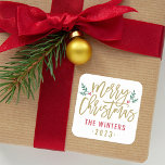 Modern Gold Script Merry Christmas Custom Square Sticker<br><div class="desc">Stylish Merry Christmas holiday favor sticker features antique gold script writing and accents of green branches with holly leaves and red berries. Personalize with custom name / family and year text. The white background color can be modified.</div>