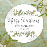 Modern Greenery Merry Christmas Family Name Classic Round Sticker<br><div class="desc">Watercolor greenery frames elegant script Merry Christmas typography on these elegant holiday stickers. Personalise with your family name. Designed by Thisisnotme©</div>