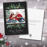 Modern Greenery Photo Merry Christmas Holiday Card<br><div class="desc">A simple and classic Christmas card look with greenery like evergreen branches, leaves, and more surround a single photo of your family or whatever you want to include. A black background gives this a modern vibe. Subtle hints and pops of color from the red holly berries give it a little...</div>
