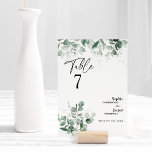 Modern Greenery White Wedding Table Number Card<br><div class="desc">This modern greenery white wedding table number card design features easy mix and match coordinating styles in black and white with delicate greenery elements adding graceful flourish around simple sophisticated typography and lovely minimal calligraphy script. The watercolor eucalyptus and other botanical leaves arch beautifully throughout, with dark emerald fading in...</div>