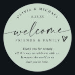 Modern Light Sage Green Wedding Welcome Hotel Bag Classic Round Sticker<br><div class="desc">Light Sage Hotel Bag Stickers: Soft and fresh, these light sage modern handwriting wedding welcome stickers bring a natural elegance to your wedding weekend. Each 3-inch round sticker features the phrase “welcome friends & family” with a small heart accent and space for your short message. The couple’s names and wedding...</div>