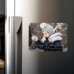 Modern Merry Christmas Script Snow Flurries Photo Magnet<br><div class="desc">Wish friends and family a Merry Christmas with a cute holiday photo magnet! The magnet features your horizontal photo with subtle snow flurries bordering the design. "Merry Christmas" is displayed in a white,  trendy calligraphy script with your family's name below.</div>