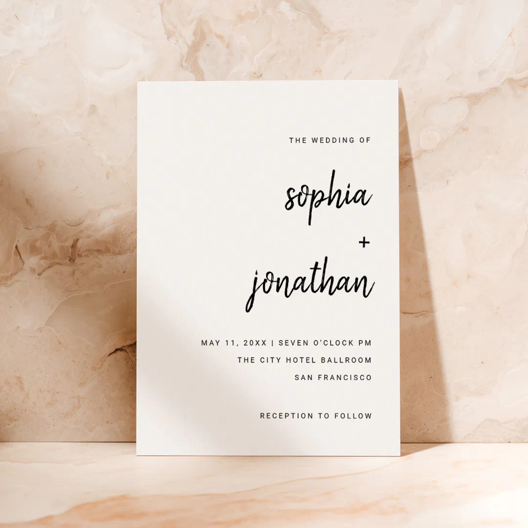The invitation design illustrates black scripted text with white as the overall color. The background looks like a beige marble-effect.