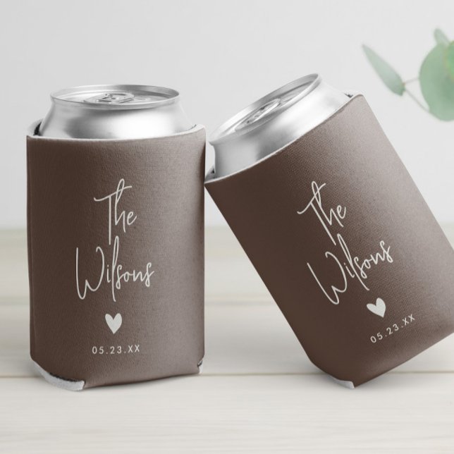 Modern Minimalist Wedding Elegant Last Name Can Cooler (A stylish script wedding can cooler with custom names and date, adorned with heart accent earth tone)