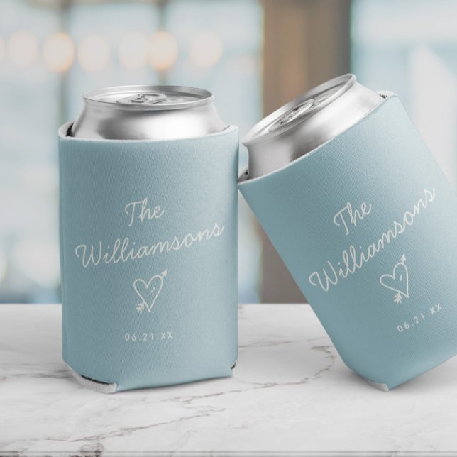 Modern Minimalist Wedding Simple Last Name Can Cooler (Two light blue can coolers with the text 'The Williams' and date and a heart with arrow,)
