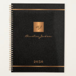 Modern monogrammed black gold elegant name script planner<br><div class="desc">Luxury exclusive looking monogrammed stylish personalized planner featuring a faux gold copper metallic glitter square and lines over a stylish classy black leather look background.           Personalize it with your text,  your name and monogram initials.</div>