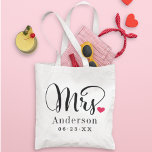 Modern Mrs Heart Calligraphy Monogram Tote Bag<br><div class="desc">Celebrate the new "Mrs." with this charming tote featuring bold calligraphy script accented by a sweet pink heart, a personalized last name, and wedding date. A romantic monogram keepsake perfect for the honeymoon, bridal shower, or as an everyday reminder of the big day. Last name and date are fully customizable....</div>