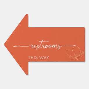 Modern orange restrooms "this way" arrow sign